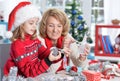 Portrait of grandmother with girl preparing for Christmas