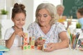 Portrait of grandmother and granddaughter with cubes