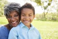 Portrait Of Grandmother With Grandson Relaxing In Park