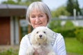 Portrait of a woman holding her dog in her arms Royalty Free Stock Photo