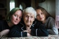 Portrait of grandmother with two girl great-granddaughters