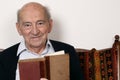 Portrait of a grandpa reading a book Royalty Free Stock Photo