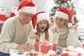 Portrait of grandparents with grandchild preparing for Christmas Royalty Free Stock Photo