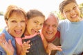 Portrait Of Grandparents And Grandchildren In Garden