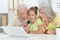 Portrait of grandparents with granddaughter singing karaoke Royalty Free Stock Photo