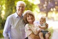 Portrait Of Grandparents Walking In Outdoors With Baby Grandson Royalty Free Stock Photo