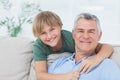 Portrait of grandson embracing grandfather Royalty Free Stock Photo