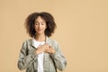 Portrait of grateful, hopeful woman holding hands on chest Royalty Free Stock Photo