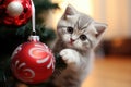 AI generated. Portrait of gray cute kitty cat sitting on the floor and playing with Christmas tree toy balls Royalty Free Stock Photo