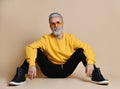 Portrait of gray hair senior millionaire man in yellow sunglasses pointing fingers up Royalty Free Stock Photo