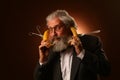 Portrait of a gray-haired elderly gentleman, with a shaggy mustache and beard, in a white shirt and gray jacket, wearing glasses Royalty Free Stock Photo