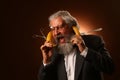 Portrait of a gray-haired elderly gentleman, with a shaggy mustache and beard, in a white shirt and gray jacket, wearing glasses Royalty Free Stock Photo