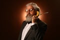 Portrait of a gray-haired elderly gentleman, with a shaggy mustache and beard, in a white shirt and gray jacket, wearing glasses Royalty Free Stock Photo