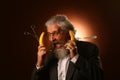 Portrait of a gray-haired elderly gentleman, with a shaggy mustache and beard, in a white shirt and gray jacket, wearing glasses Royalty Free Stock Photo