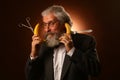 Portrait of a gray-haired elderly gentleman, with a shaggy mustache and beard, in a white shirt and gray jacket, wearing glasses Royalty Free Stock Photo