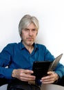 Portrait of a gray-haired elderly man with a short beard, wearing glasses to reflect on the meaning of life, the past years with t Royalty Free Stock Photo