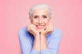 Portrait of gray haired happy beautiful old lady with beaming smile, healthy teeth, isolated over violet background Royalty Free Stock Photo