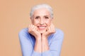 Portrait of gray haired happy beautiful old lady with beaming smile, healthy teeth, isolated over violet background Royalty Free Stock Photo