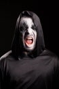 Portrait of grim reaper screaming over black background Royalty Free Stock Photo