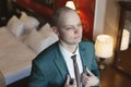 Portrait of the groom adjusting his suit and getting ready to meet the bride. Royalty Free Stock Photo