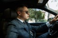 portrait of a groom driving a car