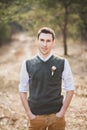 Portrait of groom in park on wedding day