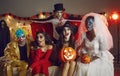 Portrait of group of adult creative friends in various spooky images at Halloween party. Royalty Free Stock Photo