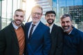 Portrait of a group of business men looking at camera with smiley expression. Male coworkers staring front. Masculine Royalty Free Stock Photo