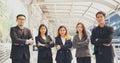 Portrait Group of businesspeople arms crossed smiling look at camera in modern city background. Happy Businessman, businesswoman