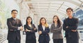 Portrait Group of businesspeople arms crossed smiling look at camera in modern city background. Happy Businessman, businesswoman