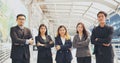 Portrait Group of businesspeople arms crossed smiling look at camera in modern city background. Happy Businessman, businesswoman