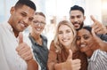 Portrait of a group of confident diverse businesspeople gesturing thumbs up and taking selfies together in an office Royalty Free Stock Photo