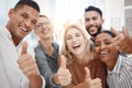 Portrait of a group of confident diverse businesspeople gesturing thumbs up and taking selfies together in an office Royalty Free Stock Photo