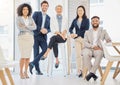 Portrait of a group of confident diverse businesspeople posing together in an office. Happy smiling colleagues motivated Royalty Free Stock Photo