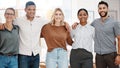 Portrait of a group of confident diverse businesspeople standing with arms around each other in an office. Happy smiling Royalty Free Stock Photo