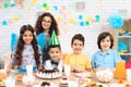 Portrait of group of joyful children at birthday party. Children at festive table.