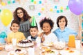 Portrait of group of joyful children at birthday party. Children at festive table.