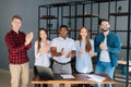 Portrait of group of multi-ethnic business people applauding and gratefully looking into camera Royalty Free Stock Photo