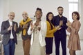 Portrait of group of multiethnic business people applauding and proudly smiling looking at camera. Royalty Free Stock Photo