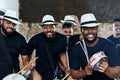 Playing together in sync to the beat. Portrait of a group of musical performers playing together indoors.