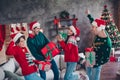 Portrait of group positive young people hold festive christmas giftbox dancing have fun loft interior flat indoors Royalty Free Stock Photo