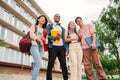 Portrait of a group of smiling multiracial university students carrying backpacks and folders, standing at campus Royalty Free Stock Photo