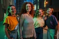 Portrait of a group of young adult women standing together at night time. Four teenage girls smiling together, looking Royalty Free Stock Photo