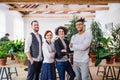 Group of young businesspeople standing in office, looking at camera. Royalty Free Stock Photo