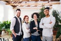 Group of young businesspeople standing in office, looking at camera. Royalty Free Stock Photo