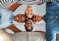 Portrait of a group of young diverse businesspeople smiling and huddling in support at work. Cheerful colleagues Royalty Free Stock Photo