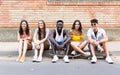Group of young hipster friends looking at camera in an urban area. Royalty Free Stock Photo