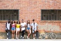 Group of young hipster friends looking at camera in an urban area. Royalty Free Stock Photo