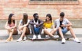 Group of young hipster friends talking in an urban area. Royalty Free Stock Photo