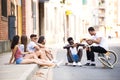 Group of young hipster friends talking in an urban area. Royalty Free Stock Photo